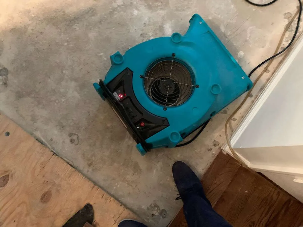 Air mover drying subfloor during Commercial Water Damage Restoration in East Wenatchee